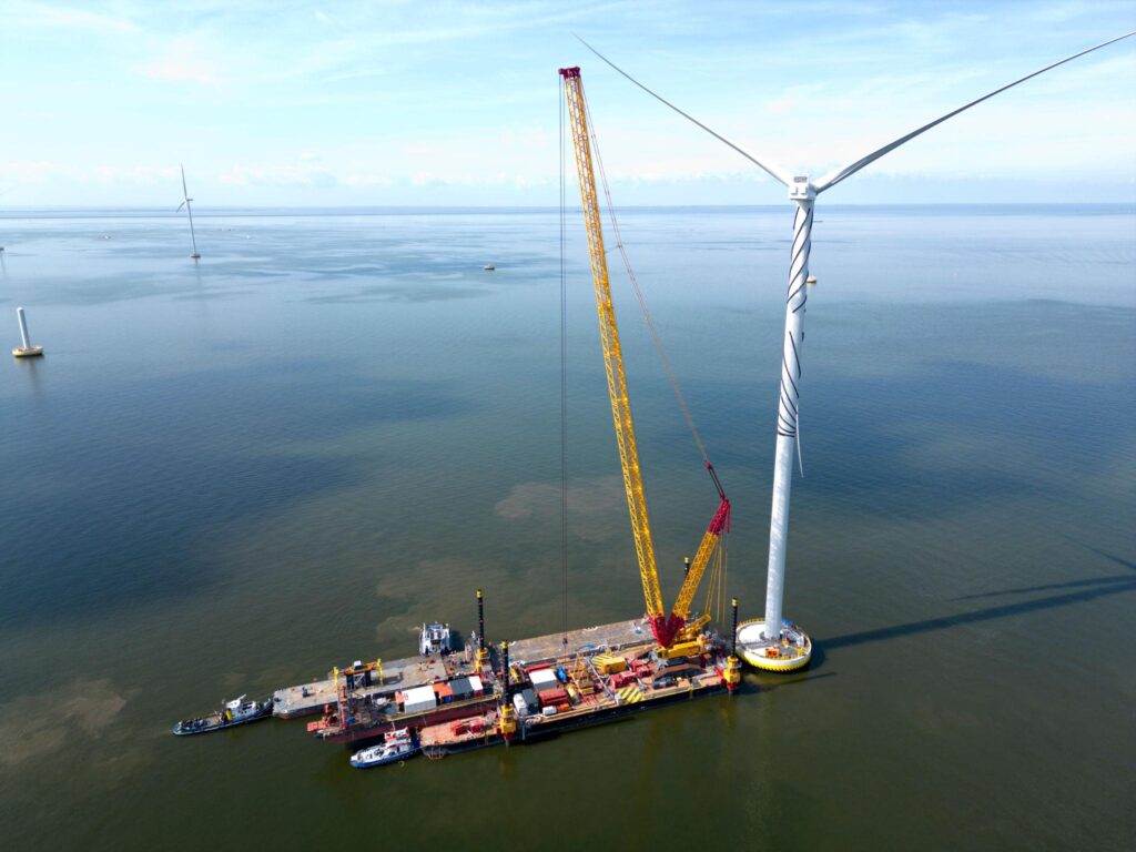 Offshore wind turbine installation using heavy lifting crane in marine construction project